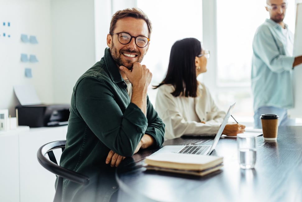 stock-photo-business-man-smiling-at-the-camera-while-sitting-in-a-boardroom-during-a-meeting-happy-business-2310823493