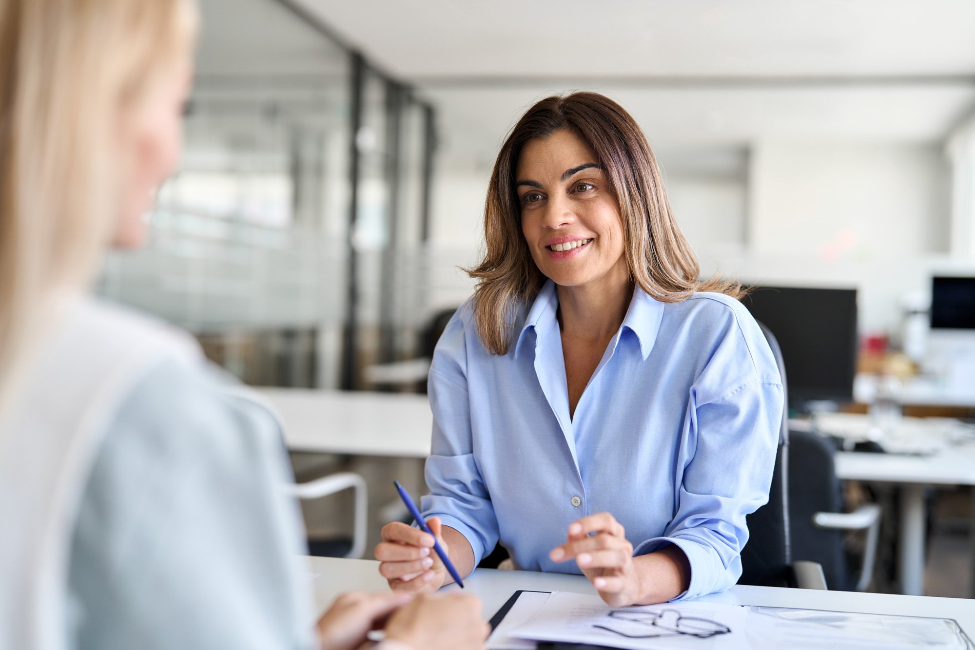 stock-photo-happy-middle-aged-business-woman-hr-talking-to-recruit-at-job-interview-meeting-smiling-mature-2454482081